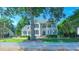 Beautiful two-story home featuring a lush green lawn, mature trees and a classic white picket fence at 8042 Hogan Dr, Wake Forest, NC 27587