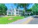 Inviting home exterior with an American flag, green lawn, and white picket fence offering timeless charm at 8042 Hogan Dr, Wake Forest, NC 27587