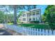 Charming two-story home with a manicured front yard and white picket fence creating an inviting curb appeal at 8042 Hogan Dr, Wake Forest, NC 27587