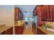 Galley kitchen with stainless steel appliances, wood cabinets, and long granite countertops at 8042 Hogan Dr, Wake Forest, NC 27587