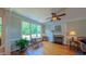 Inviting living room with fireplace, large windows, and hardwood floors. Bench seat under window at 8042 Hogan Dr, Wake Forest, NC 27587