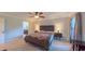 Comfortable main bedroom with a ceiling fan, plush carpet, and ensuite bathroom access at 8042 Hogan Dr, Wake Forest, NC 27587
