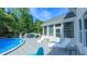 Backyard with pool, deck, sunroom and patio furniture, perfect for outdoor entertaining at 8042 Hogan Dr, Wake Forest, NC 27587