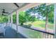 Scenic porch view with white railing overlooking lush greenery and manicured lawns at 8042 Hogan Dr, Wake Forest, NC 27587