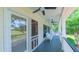 Inviting porch with white wicker seating and peaceful views of the surrounding landscape at 8042 Hogan Dr, Wake Forest, NC 27587