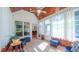 Cozy sunroom with wood ceiling, bright windows, and access to the backyard at 8042 Hogan Dr, Wake Forest, NC 27587
