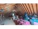 Unfinished attic showing exposed wood beams and rafters with storage space at 8042 Hogan Dr, Wake Forest, NC 27587