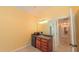 Cozy wet bar area features a mini fridge, microwave, sink, and vanity lights leading to the hallway at 8042 Hogan Dr, Wake Forest, NC 27587