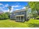 Rear view of a house with a large, well-manicured lawn, and a screened-in porch at 805 Alden Bridge Dr, Cary, NC 27519