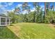 Grassy backyard featuring well-maintained lawn, surrounding mature trees, and privacy at 805 Alden Bridge Dr, Cary, NC 27519