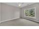 Bedroom with neutral paint, carpet, ceiling fan and one window with backyard view at 805 Alden Bridge Dr, Cary, NC 27519