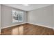 Bedroom features hardwood flooring, neutral paint, and a large window with natural light at 805 Alden Bridge Dr, Cary, NC 27519