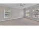 Spacious carpeted bedroom filled with light from two windows; neutral paint and trim at 805 Alden Bridge Dr, Cary, NC 27519