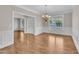 Dining room boasts wainscoting, hardwood floors, chandelier, and natural light from window at 805 Alden Bridge Dr, Cary, NC 27519
