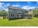 Back exterior view of a well-maintained home with a screened-in porch and large backyard at 805 Alden Bridge Dr, Cary, NC 27519