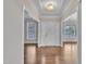 Spacious front entrance with hardwood flooring, stylish lighting, and access to multiple rooms at 805 Alden Bridge Dr, Cary, NC 27519