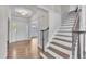 Grand foyer with hardwood floors, elegant staircase, and a view into the living spaces at 805 Alden Bridge Dr, Cary, NC 27519