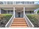 Inviting front porch with brick steps, white columns and trim, providing a charming entrance at 805 Alden Bridge Dr, Cary, NC 27519