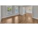 Bright living room features hardwood floors, white trim, and large windows with natural light at 805 Alden Bridge Dr, Cary, NC 27519