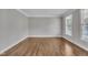 Spacious living room boasts hardwood flooring, neutral paint, and bright, natural light at 805 Alden Bridge Dr, Cary, NC 27519