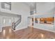 Open-concept living room with hardwood floors, staircase, and balcony overlooking the kitchen at 805 Alden Bridge Dr, Cary, NC 27519