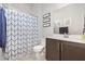 Bathroom featuring a vanity with a dark wood cabinet and a shower with a blue patterned curtain at 816 Trumpet Vine Ct, Wendell, NC 27591