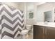 A bathroom showcases a vanity, toilet and a shower with a stylish gray chevron pattern shower curtain at 816 Trumpet Vine Ct, Wendell, NC 27591