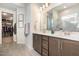 Modern bathroom featuring double vanity sinks, framed mirrors, and a glass-enclosed shower at 816 Trumpet Vine Ct, Wendell, NC 27591