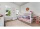 A bright bedroom featuring a bunk bed, natural light from windows, and soft, neutral decor at 816 Trumpet Vine Ct, Wendell, NC 27591