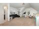 Spacious bonus room featuring a gray sectional, computer desk, and playroom for kid activities at 816 Trumpet Vine Ct, Wendell, NC 27591