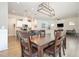 Open dining area with wood floors, modern chandelier, and easy access to the kitchen and living room at 816 Trumpet Vine Ct, Wendell, NC 27591
