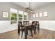 Inviting dining room featuring a modern light fixture, a large window, and stylish wall decor at 816 Trumpet Vine Ct, Wendell, NC 27591