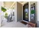 Inviting front porch with black rocking chairs, decorative accents, and a charming 'HOME' sign at 816 Trumpet Vine Ct, Wendell, NC 27591