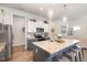 Modern kitchen featuring stainless steel appliances, a center island with barstool seating, and granite countertops at 816 Trumpet Vine Ct, Wendell, NC 27591