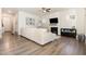 Open-concept living room with hardwood floors, a fireplace, and a large sectional sofa at 816 Trumpet Vine Ct, Wendell, NC 27591