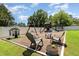 Backyard playground with swing set, playhouse, trampoline, and a seating area for to enjoy at 816 Trumpet Vine Ct, Wendell, NC 27591