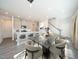 Contemporary dining area with modern table, chairs, kitchen island and open staircase at 845 Ottawa Dr, Garner, NC 27529