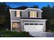 Charming two-story home with gray siding, black shutters, a two-car garage, and colorful landscaping at 845 Ottawa Dr, Garner, NC 27529