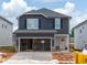 Two-story home featuring a 2-car garage, gray siding, and black shutters, offering modern curb appeal at 845 Ottawa Dr, Garner, NC 27529