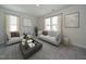 Bright and airy living room with stylish sofas, neutral decor, and large windows for ample natural light at 845 Ottawa Dr, Garner, NC 27529