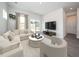 Bright living room with comfortable seating, large windows, and neutral decor, creating an inviting atmosphere at 845 Ottawa Dr, Garner, NC 27529