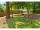 Wooden swing in spacious backyard with large trees and wooden fence at 903 W Maynard Ave, Durham, NC 27704
