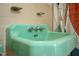 Close up of a mint green vintage sink in a retro designed bathroom at 903 W Maynard Ave, Durham, NC 27704