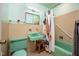Retro bathroom featuring vintage fixtures including a mint-green sink, toilet, and bathtub at 903 W Maynard Ave, Durham, NC 27704
