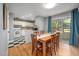 Dining room and kitchen area with hardwood floors, ample lighting, and a sliding glass door at 903 W Maynard Ave, Durham, NC 27704