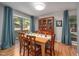 Elegant dining area with natural light, seating for six, and a large china cabinet at 903 W Maynard Ave, Durham, NC 27704
