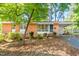 Charming brick home with a well-maintained lawn and mature tree in a quiet neighborhood at 903 W Maynard Ave, Durham, NC 27704
