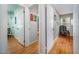 Bright hallway with hardwood floors leads to multiple rooms, showcasing the home's layout and access to various spaces at 903 W Maynard Ave, Durham, NC 27704