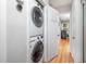 Convenient laundry area features stacked washer and dryer, and is near other rooms in the house at 903 W Maynard Ave, Durham, NC 27704