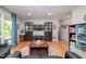 Cozy living room with large windows, hardwood floors, and a central coffee table at 903 W Maynard Ave, Durham, NC 27704